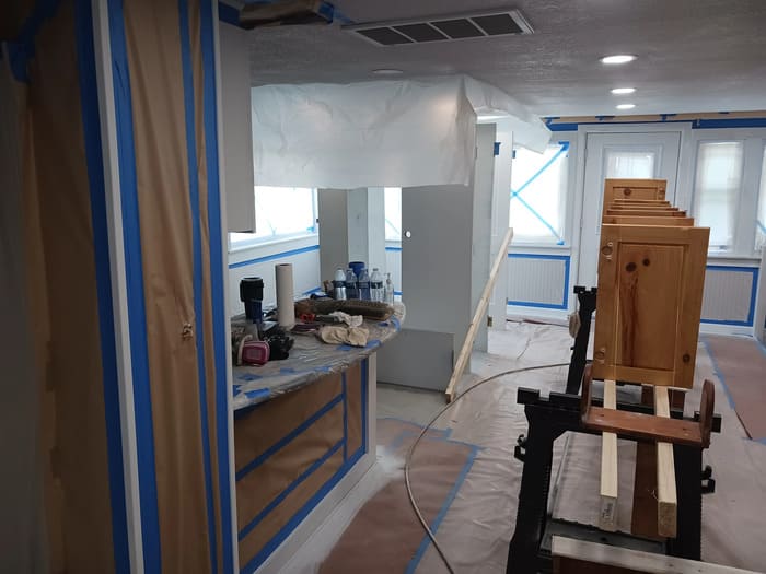 Interior room under renovation with blue painter's tape and work materials